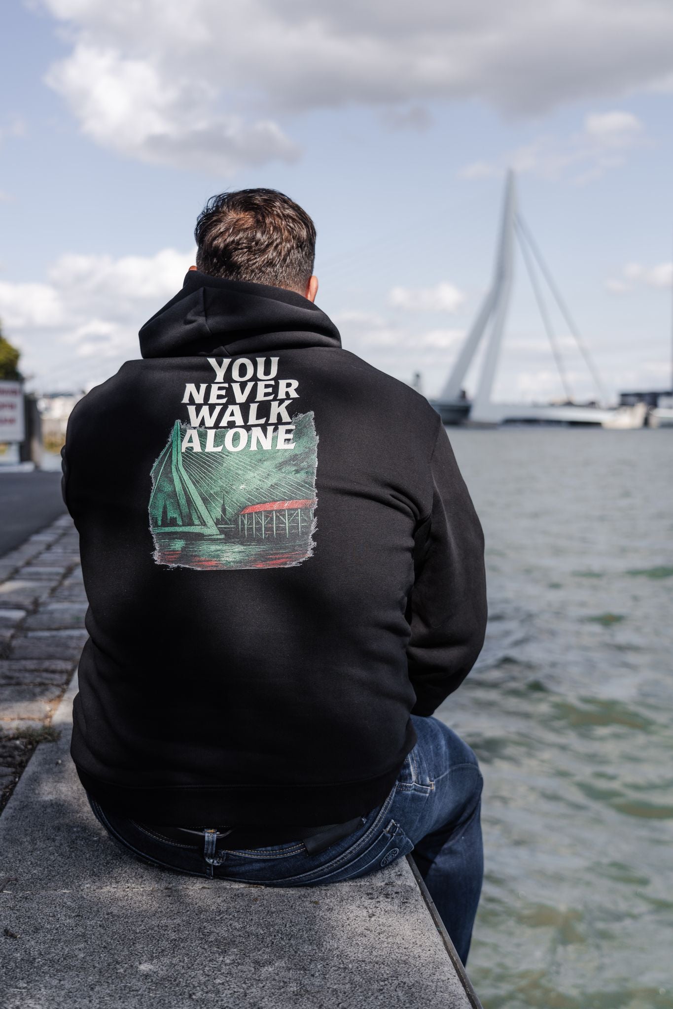 TRØBL oversized hoodie met rauw design van Rotterdam, De Kuip en geloof. Met “You Never Walk Alone” als krachtig statement. Draagbaar, stoer en eerlijk gemaakt.