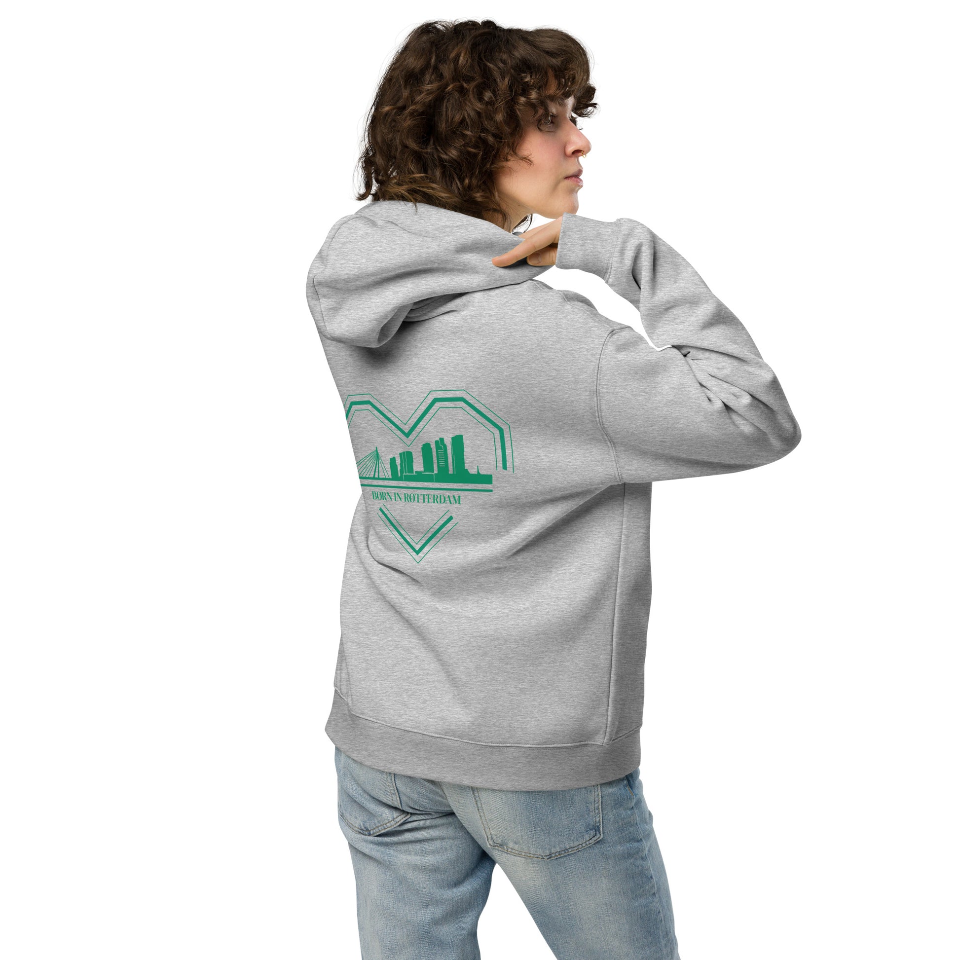 "Groen-wit ontwerp van een gebroken hart met skyline van Rotterdam en de tekst 'BØRN IN RØTTERDAM' eronder, gedrukt op een oversized TRØBL hoodie."
